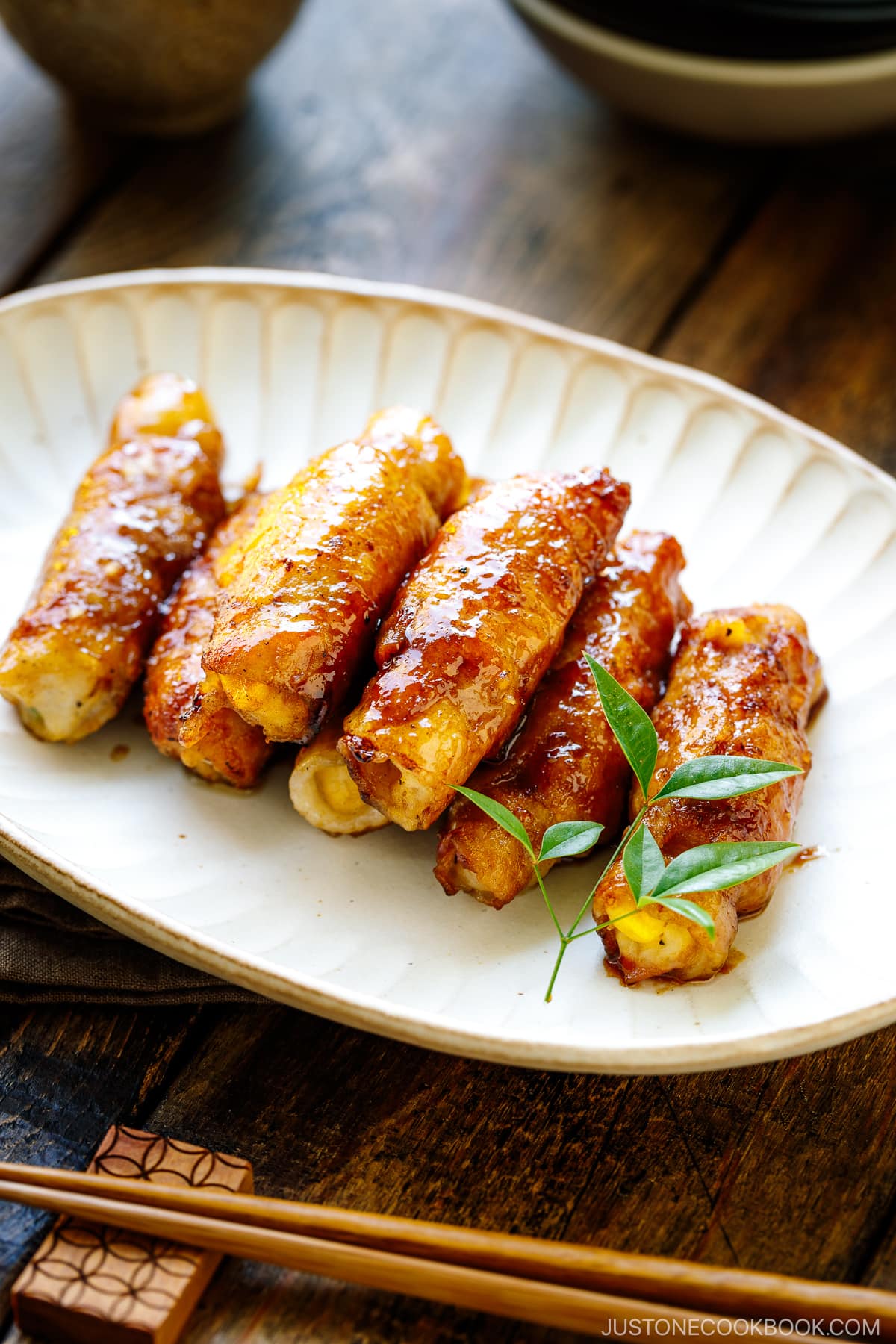 A white oval plate containing Potato Salad Pork Rolls.