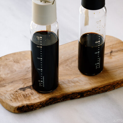 Two glass bottles containing smoked soy sauce.