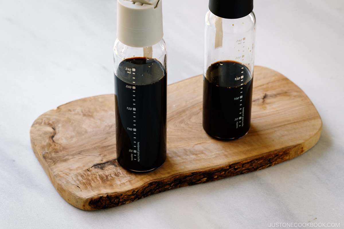 Two glass bottles containing smoked soy sauce.