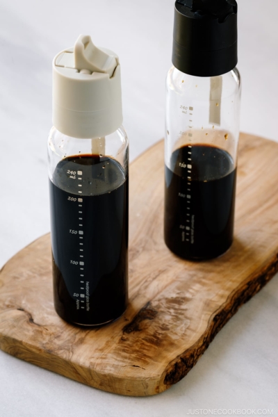 Two glass bottles containing smoked soy sauce.