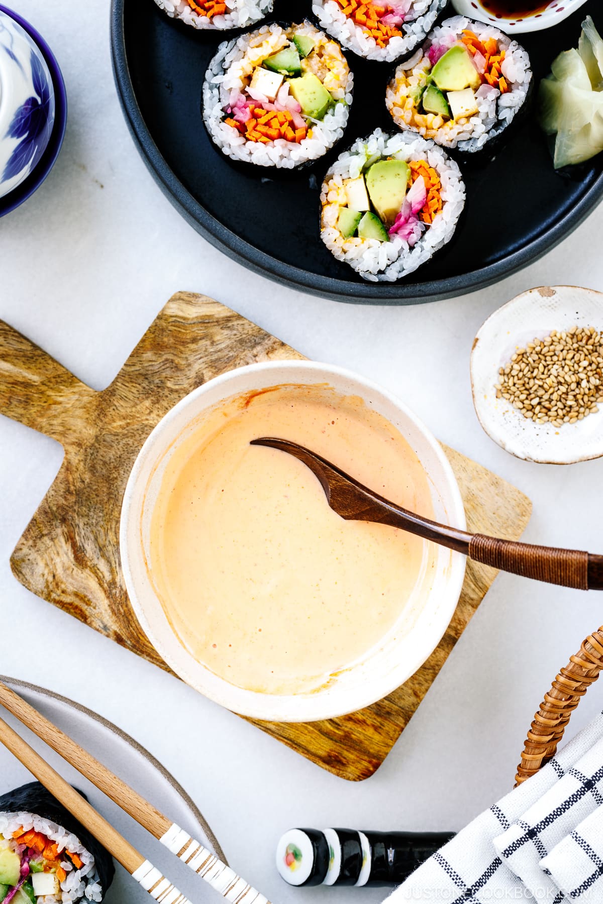 A white bowl containing spicy mayo.