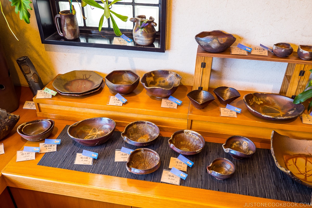 Bizen ware displayed on wood shelves