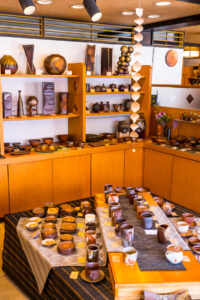 Bizen ware displayed inside a store on wood shelves
