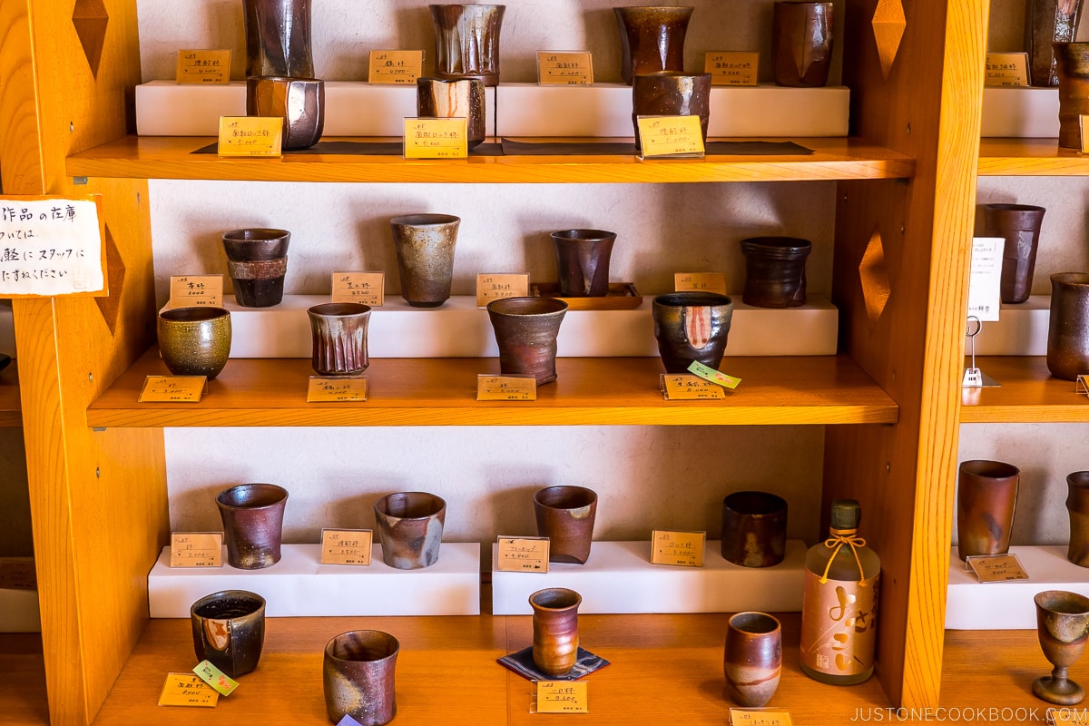 Bizen ware displayed inside a store on wood shelves