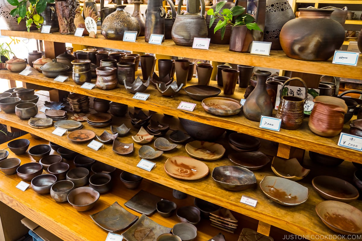 Bizen ware displayed inside a store on wood shelves