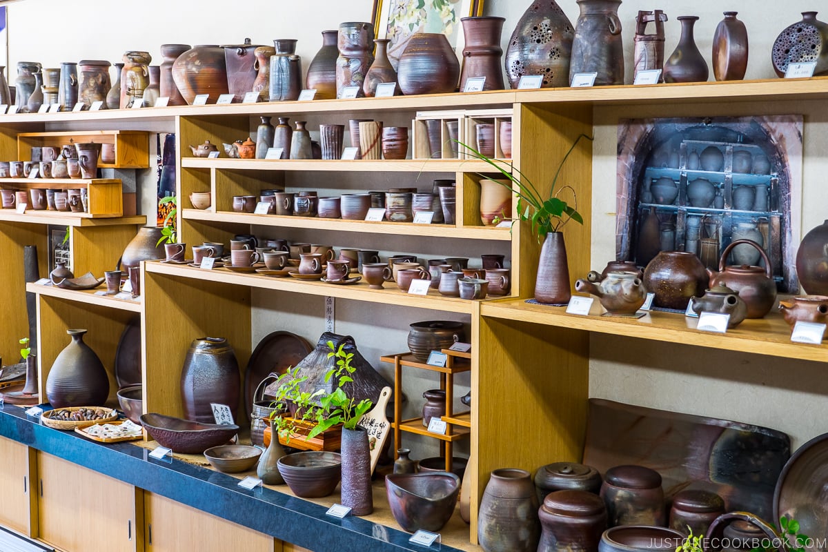 Bizen ware displayed inside a store on wood shelves