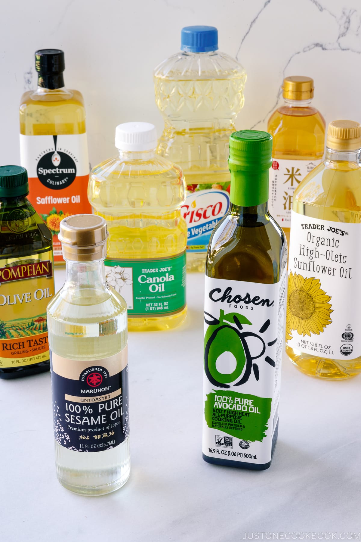 Various types of neural cooking oil displayed on the countertop.
