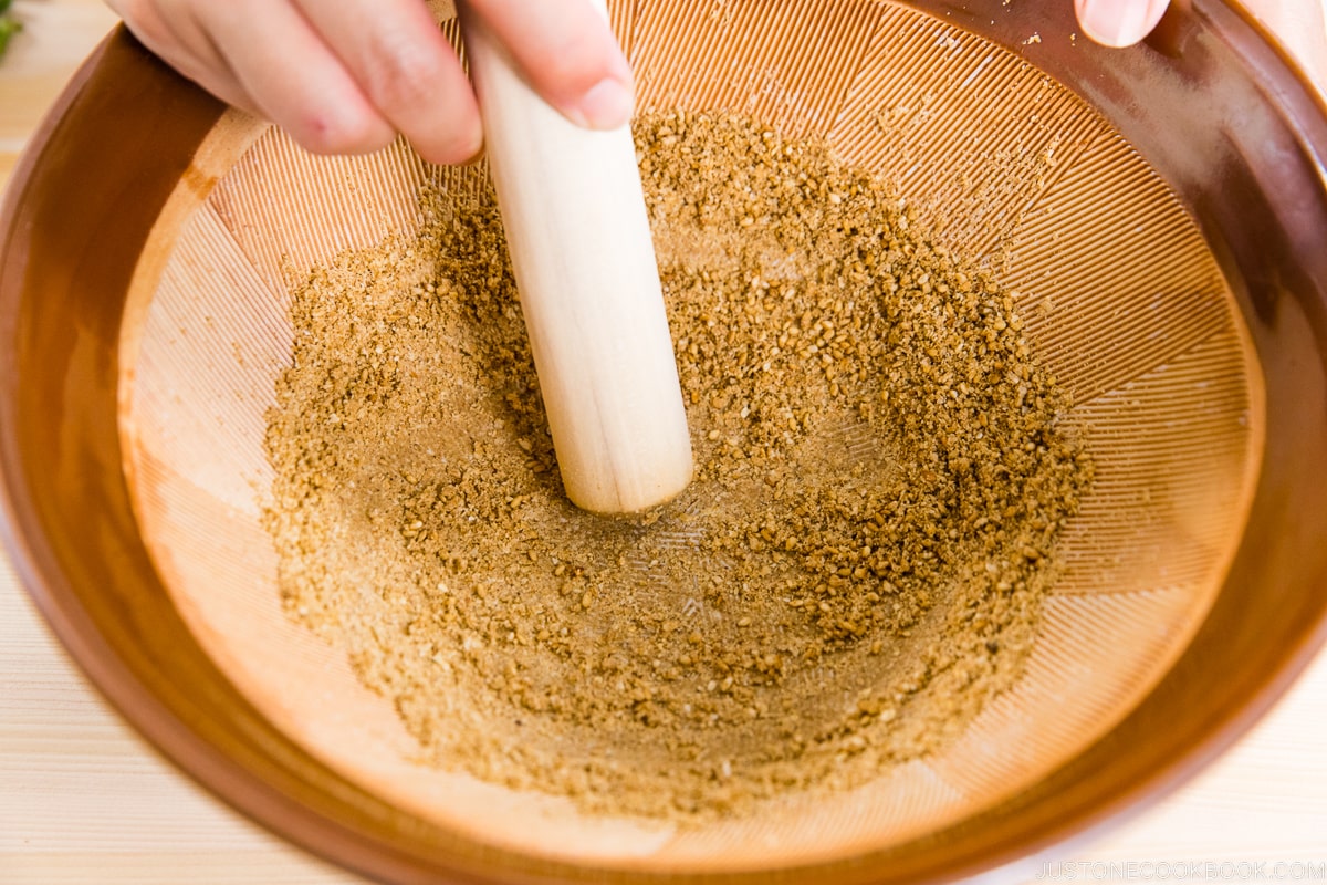 White sesame seeds ground in Japanese suribachi bowl.