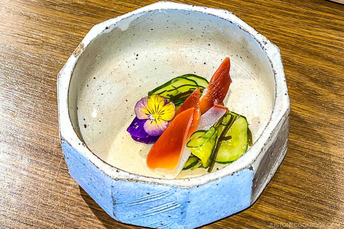 sashimi with cucumber in a white bowl