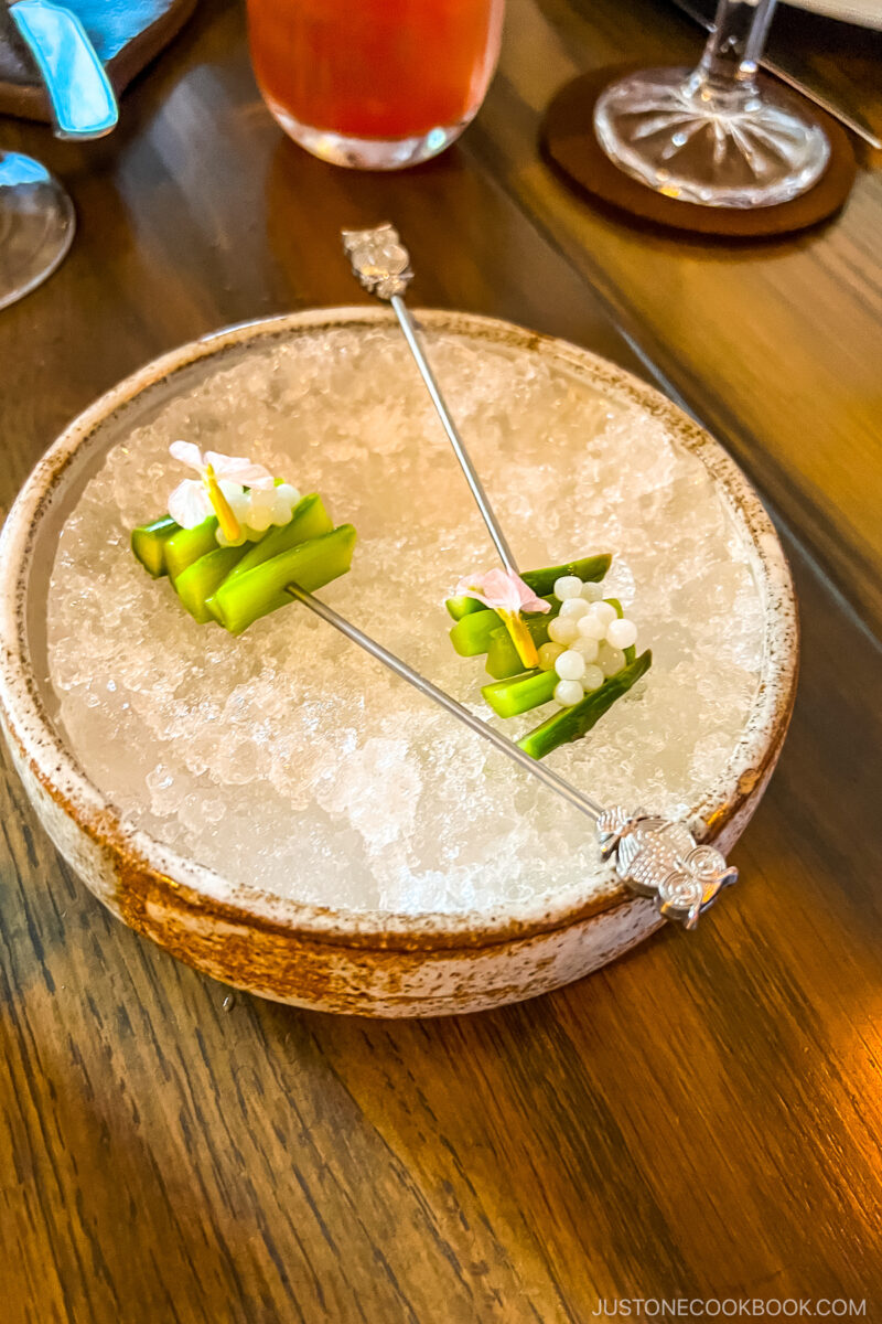 silver skewers inserted through green vegetables