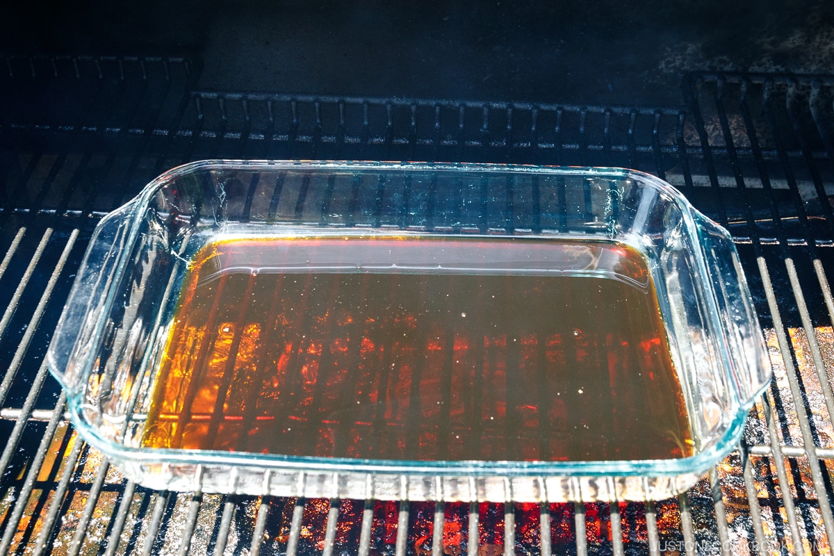 a smoker with a glass tray inside