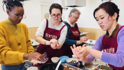 students learning how to make onigiri at BentoYa cooking class Japan