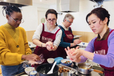 students learning how to make onigiri at BentoYa cooking class Japan