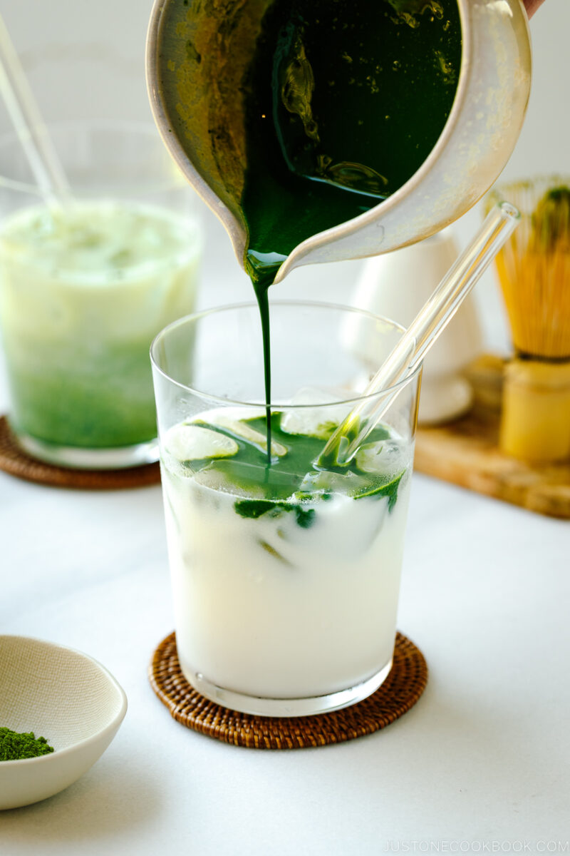 Tall glass cups containing Iced Matcha Latte.