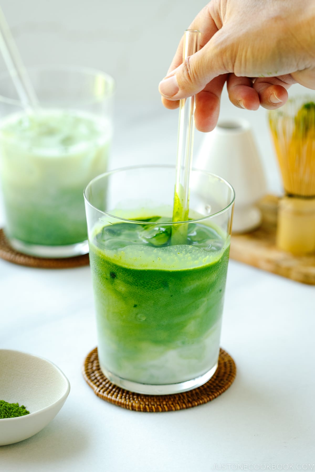 Tall glass cups containing Iced Matcha Latte.