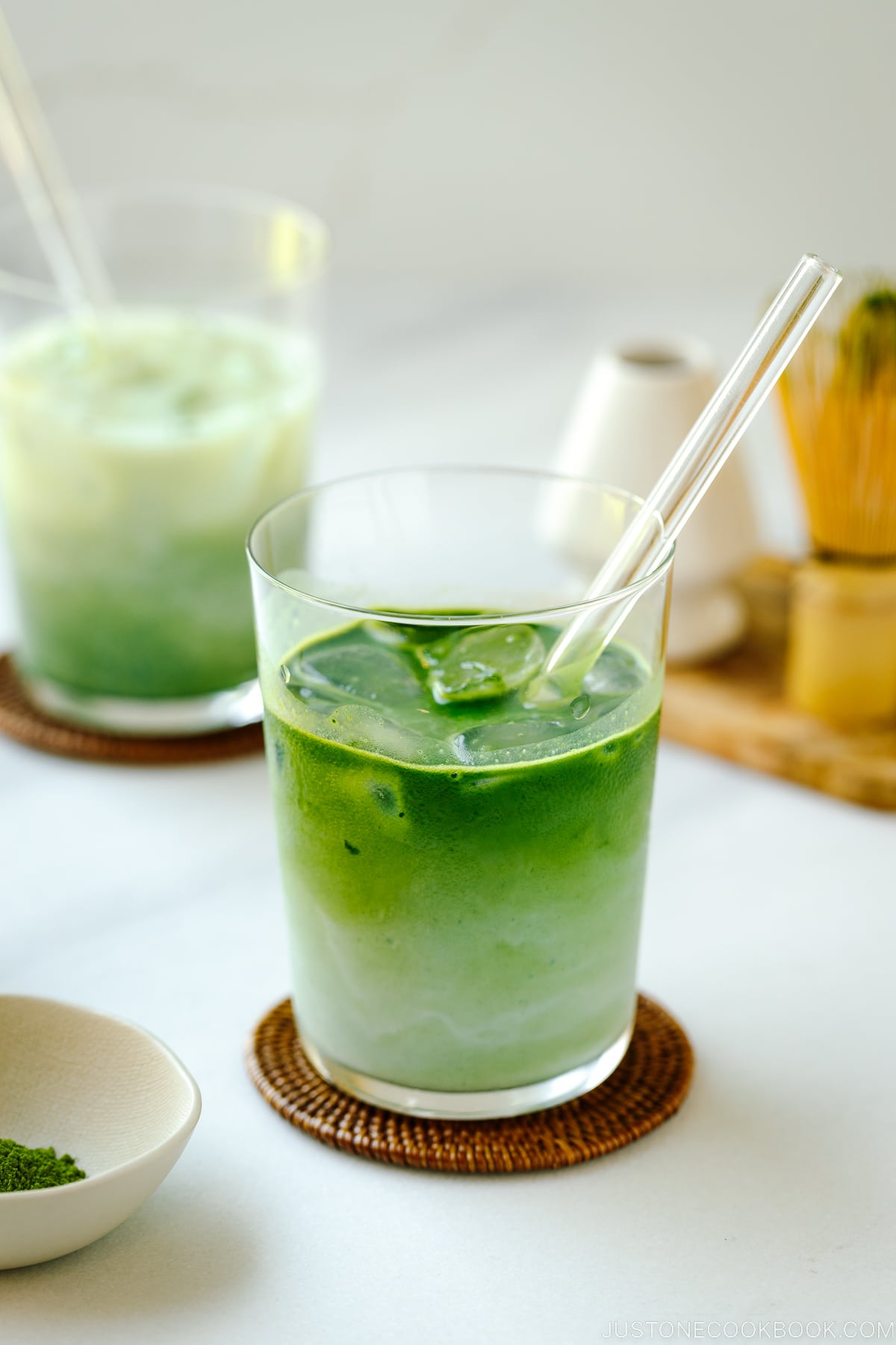 Tall glass cups containing Iced Matcha Latte.