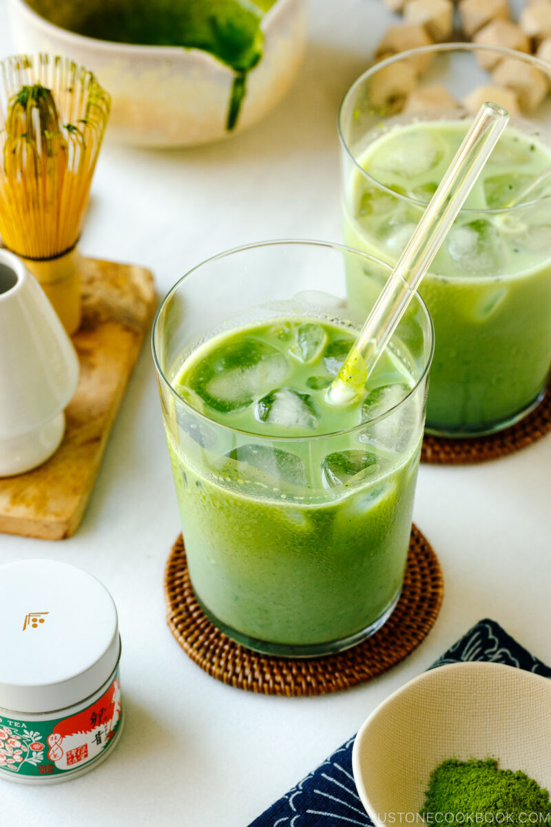 Tall glass cups containing Iced Matcha Latte.