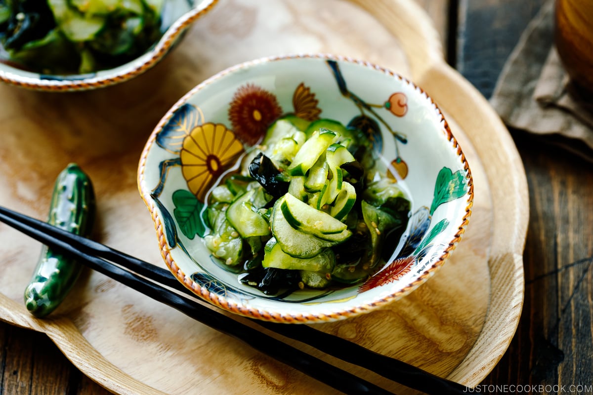 Small Japanese bowls containing Japanese cucumber salad called Sunomono.