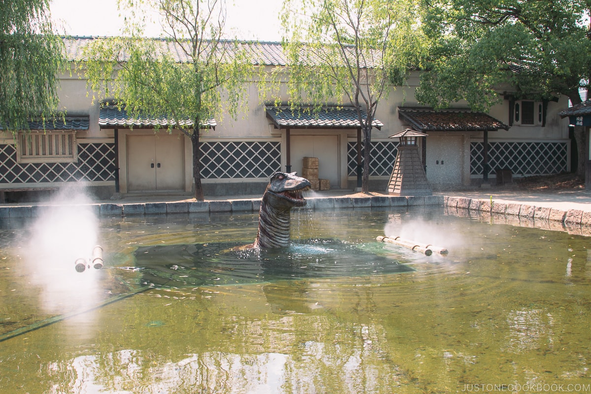 a mechanical dragon inside a pond