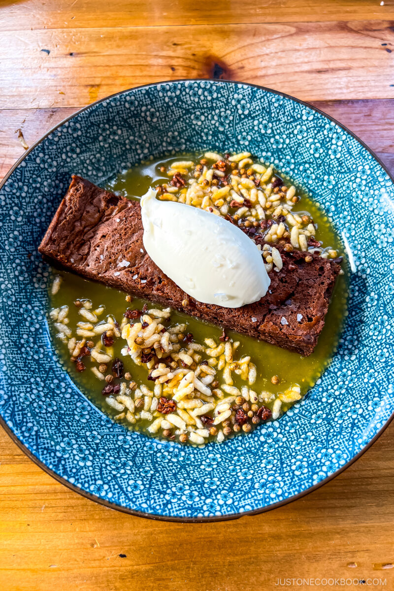 Racines Cake- Flourless chocolate cake, passion fruit caramel, candied puffed rice with cocao nibs, creme fraiche.