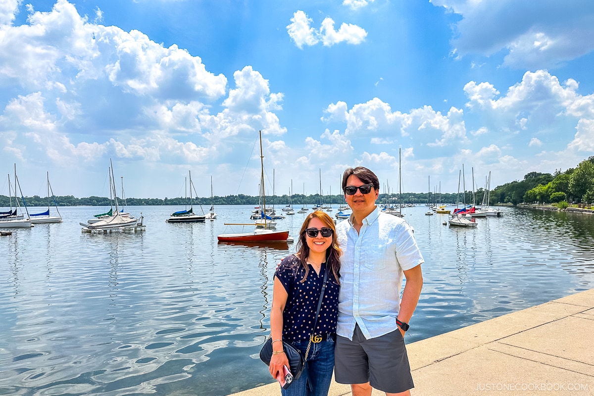two people standing next to Lake Harriet