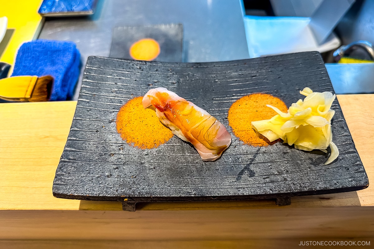 sushi on a black plate