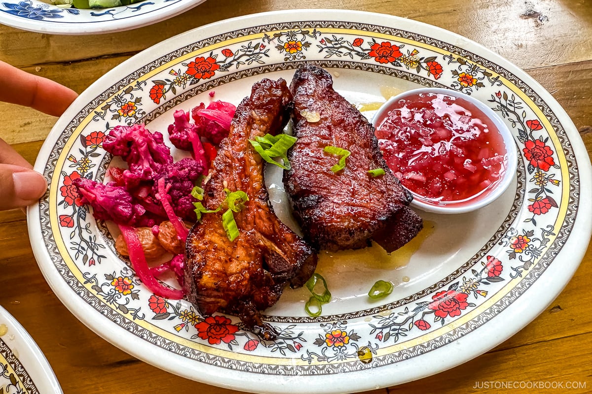 Pork Ribs Tocino - Pork ribs braised & glazed in tocino-style (sweet & savory), atchara with red peppers, carrots and purple cauliflower, and a sugarcane vinegar dipping sauce