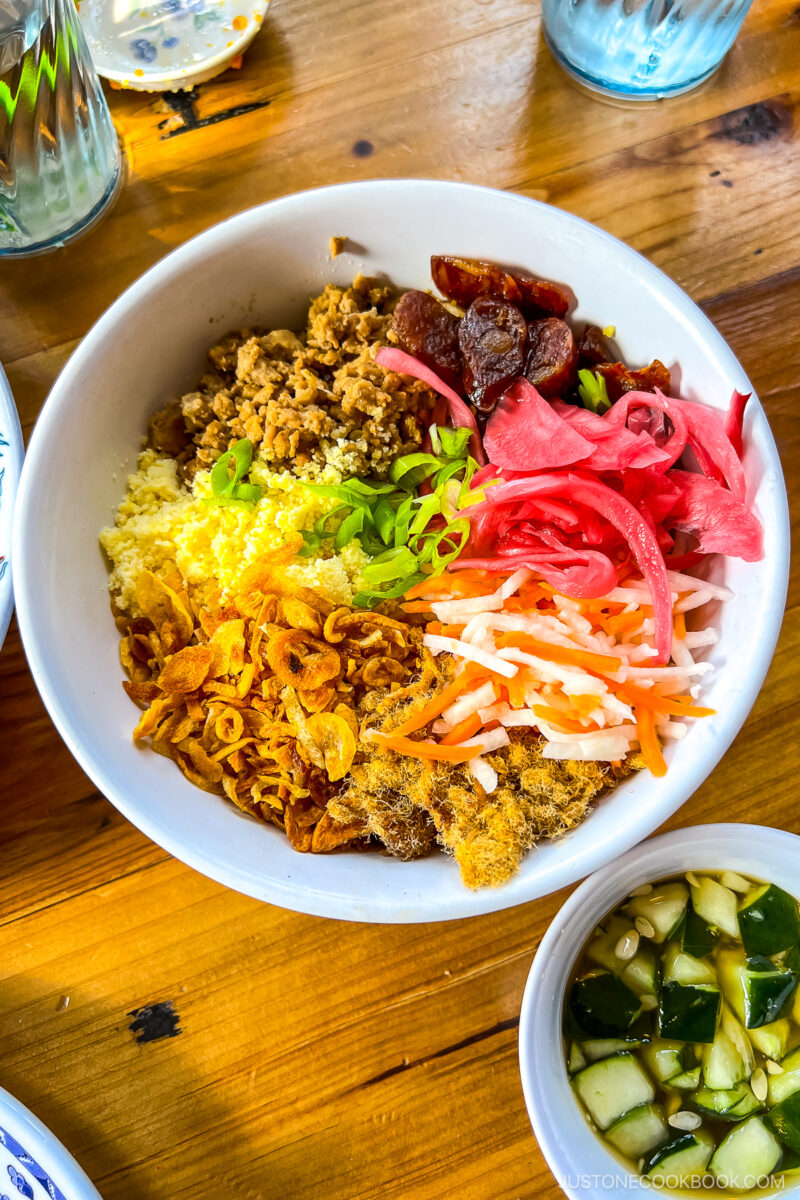 Hanoi Sticky Rice Bowl - Ground pork, pork floss, Chinese sausage, mung bean, fried shallot, pickled onion, pickled carrot & jicama, side of cucumber in nuoc cham fish sauce.
