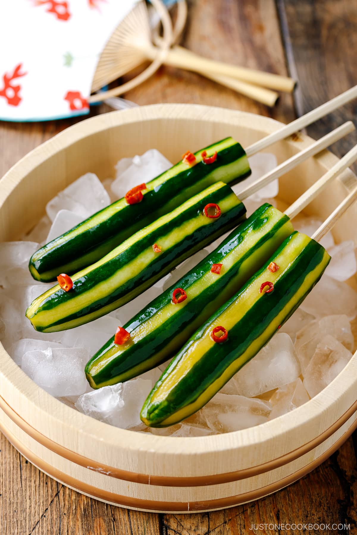 Japanese Cucumbers on a Stick served over iced cubes in wooden bowl.