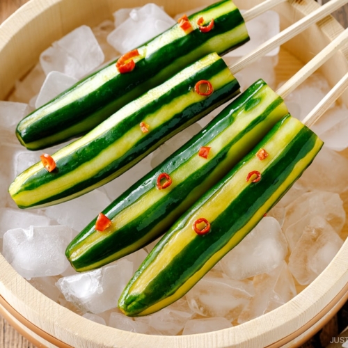 Japanese Cucumbers on a Stick served over iced cubes in wooden bowl.