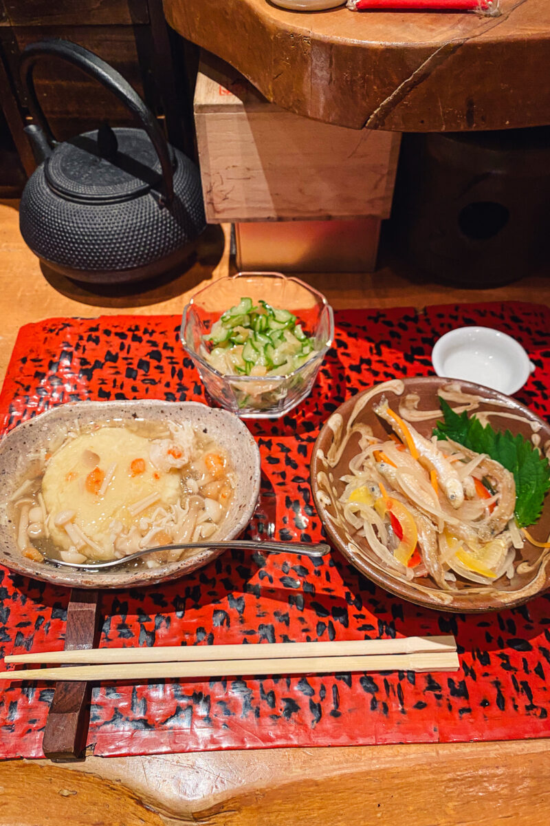 three bowls of food on a red placemat