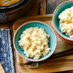 Rice bowls containing freshly cooked brown rice.