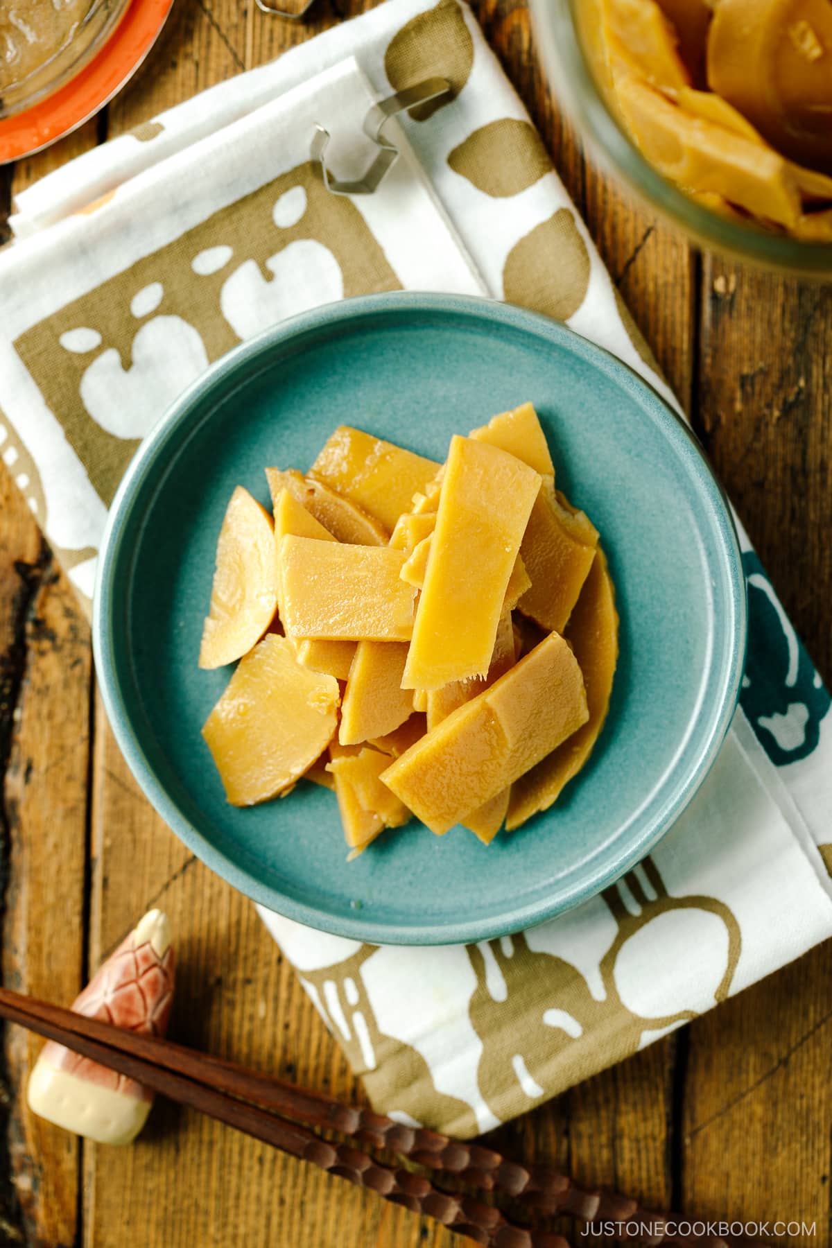 A blue plate containing menma, seasoned bamboo shoots for ramen.