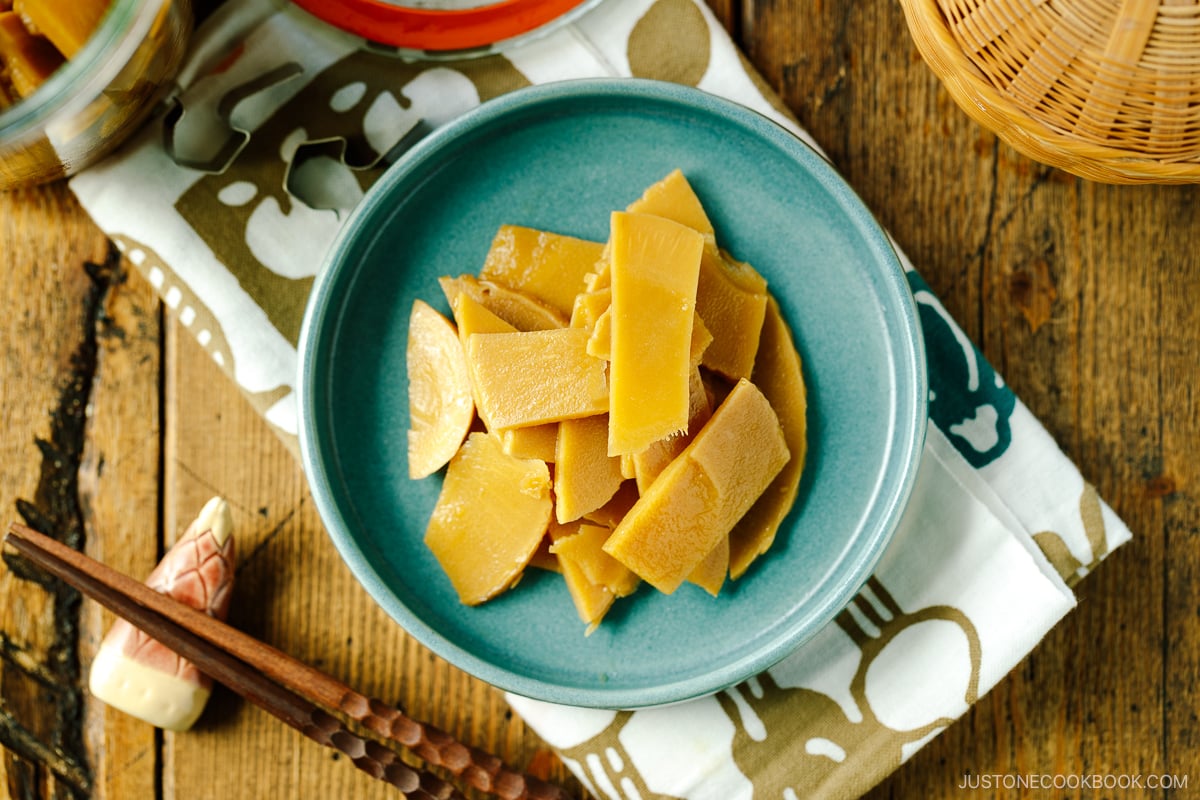 A blue plate containing menma, seasoned bamboo shoots for ramen.