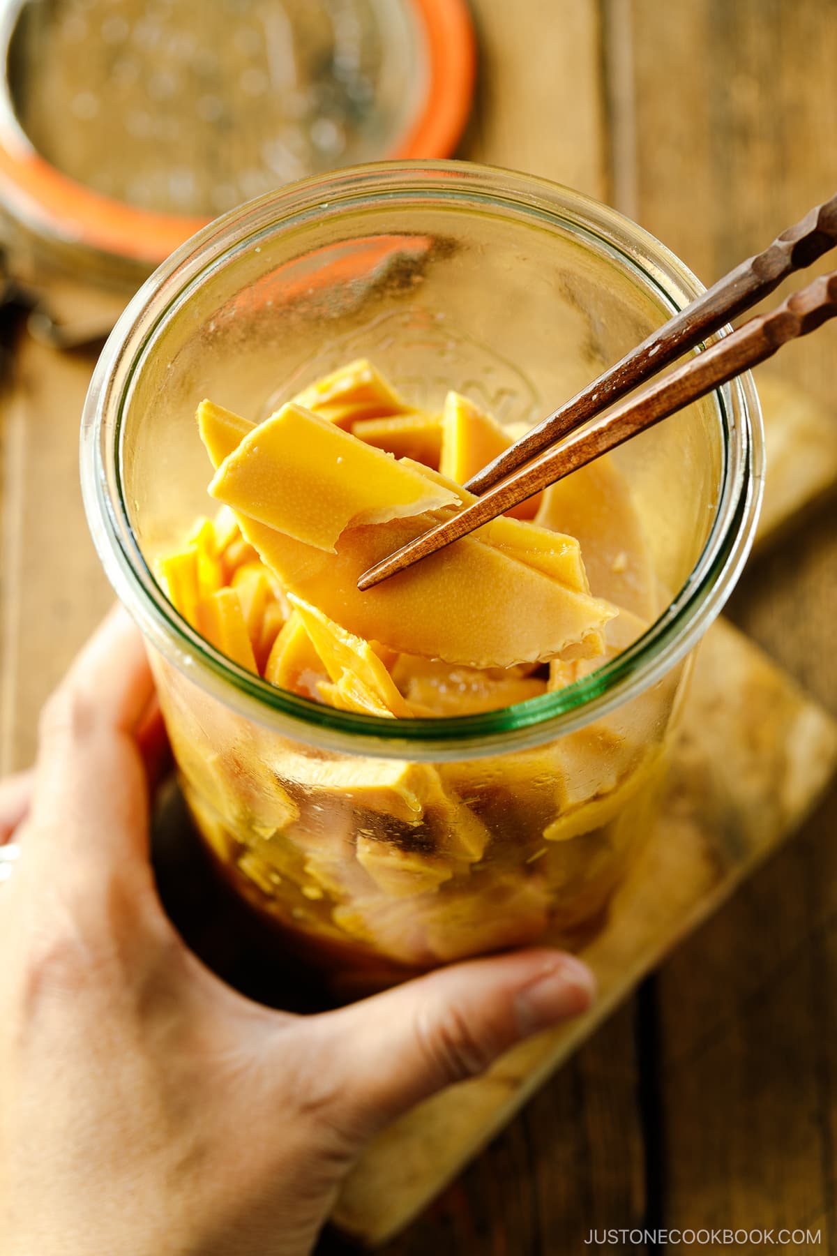 A glass Weck jar containing menma, seasoned bamboo shoots for ramen.