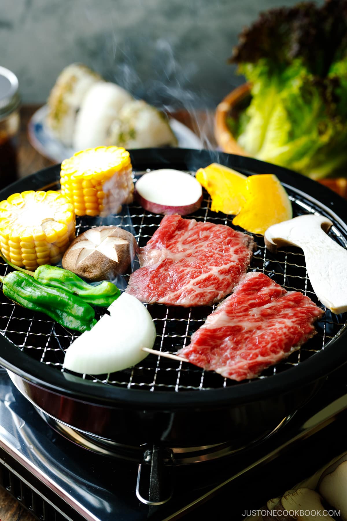 Grilling fresh vegetables and beef on a Japanese yakiniku grill top.