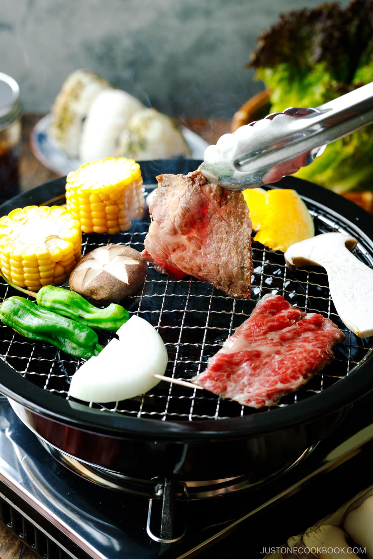 Grilling fresh vegetables and beef on a Japanese yakiniku grill top.