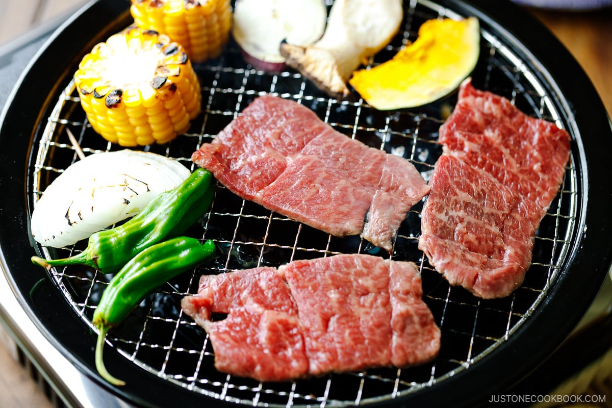 Grilling fresh vegetables and beef on a Japanese yakiniku grill top.