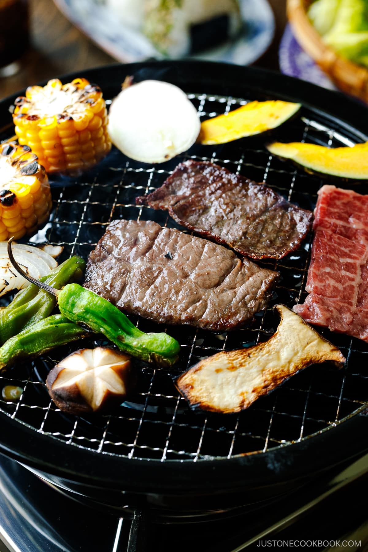 Grilling fresh vegetables and beef on a Japanese yakiniku grill top.