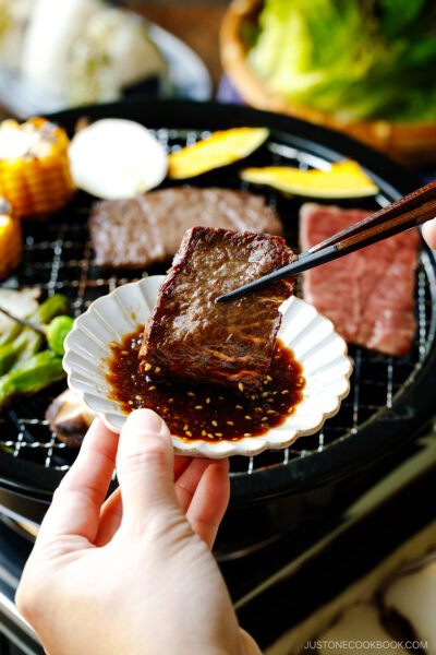 Dipping the grilled beef in the homemade Yakiniku Sauce.