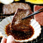 Dipping grilled beef in the homemade Yakiniku Sauce.