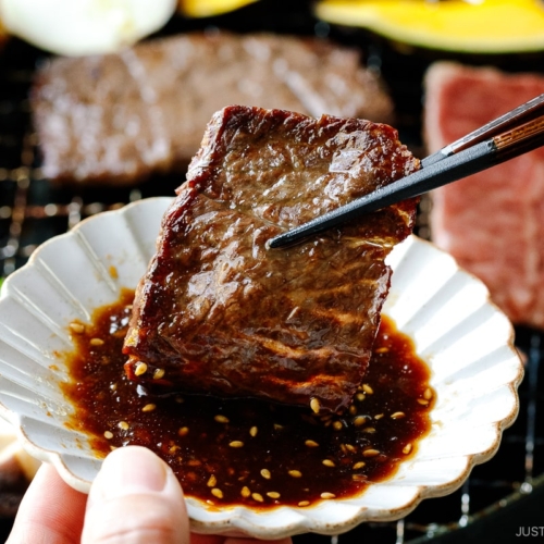 Dipping grilled beef in the homemade Yakiniku Sauce.