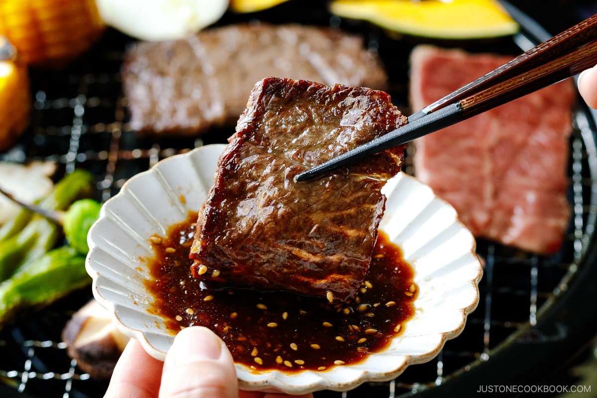 Dipping grilled beef in the homemade Yakiniku Sauce.