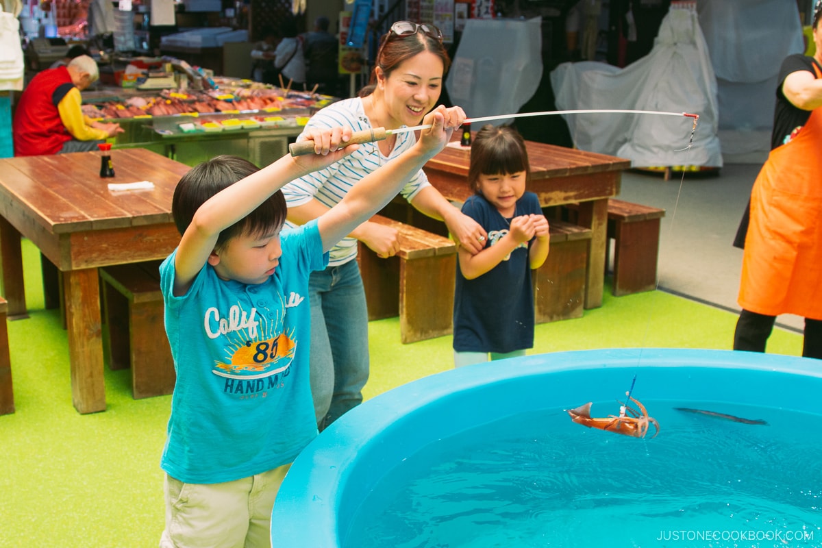 a boy catching Squid at Hakodate Market