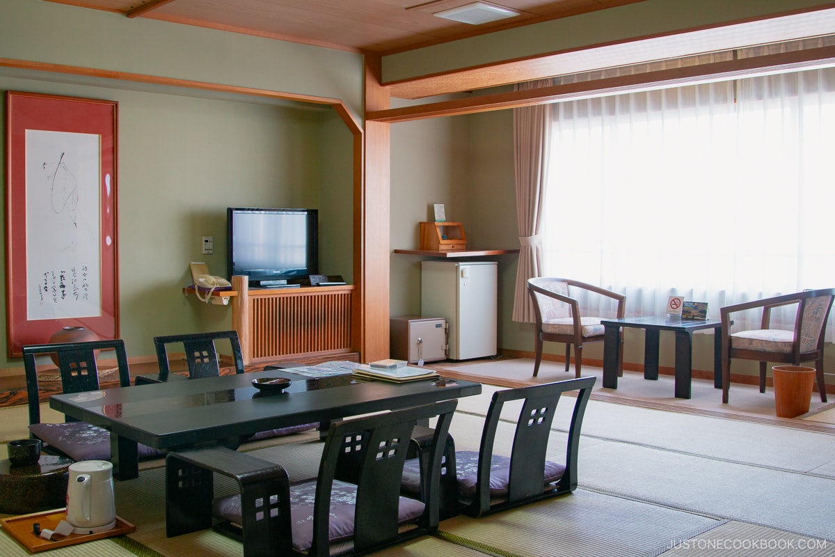 a traditional Japanese ryokan room with sitting table in the center