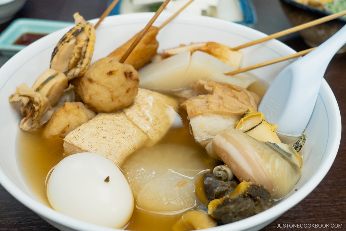 Bowl of oden including tofu, daikon radish, egg and scallops