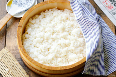 Sushi oke (Hangiri) containing sushi rice made with cooked Japanese short-grain rice, rice vinegar, sugar, and salt.