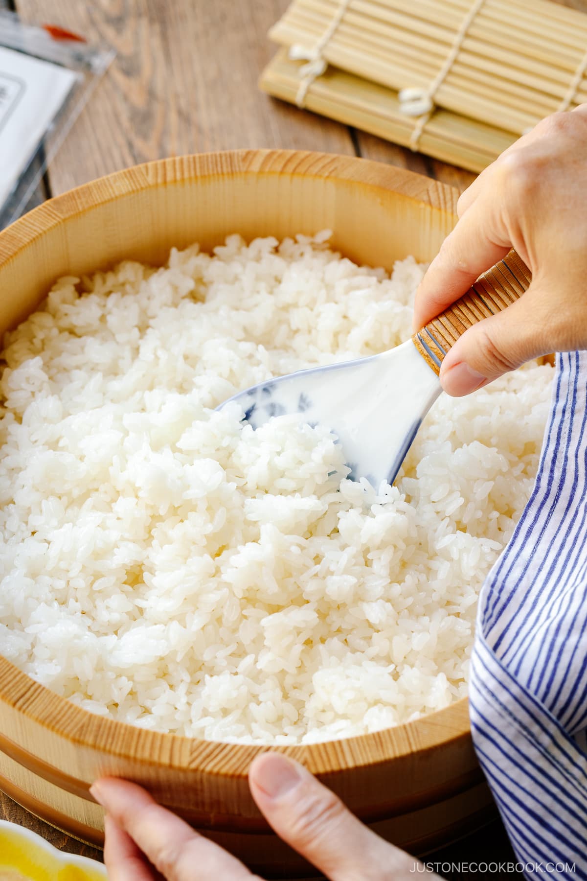 Sushi oke (Hangiri) containing sushi rice made with cooked Japanese short-grain rice, rice vinegar, sugar, and salt.