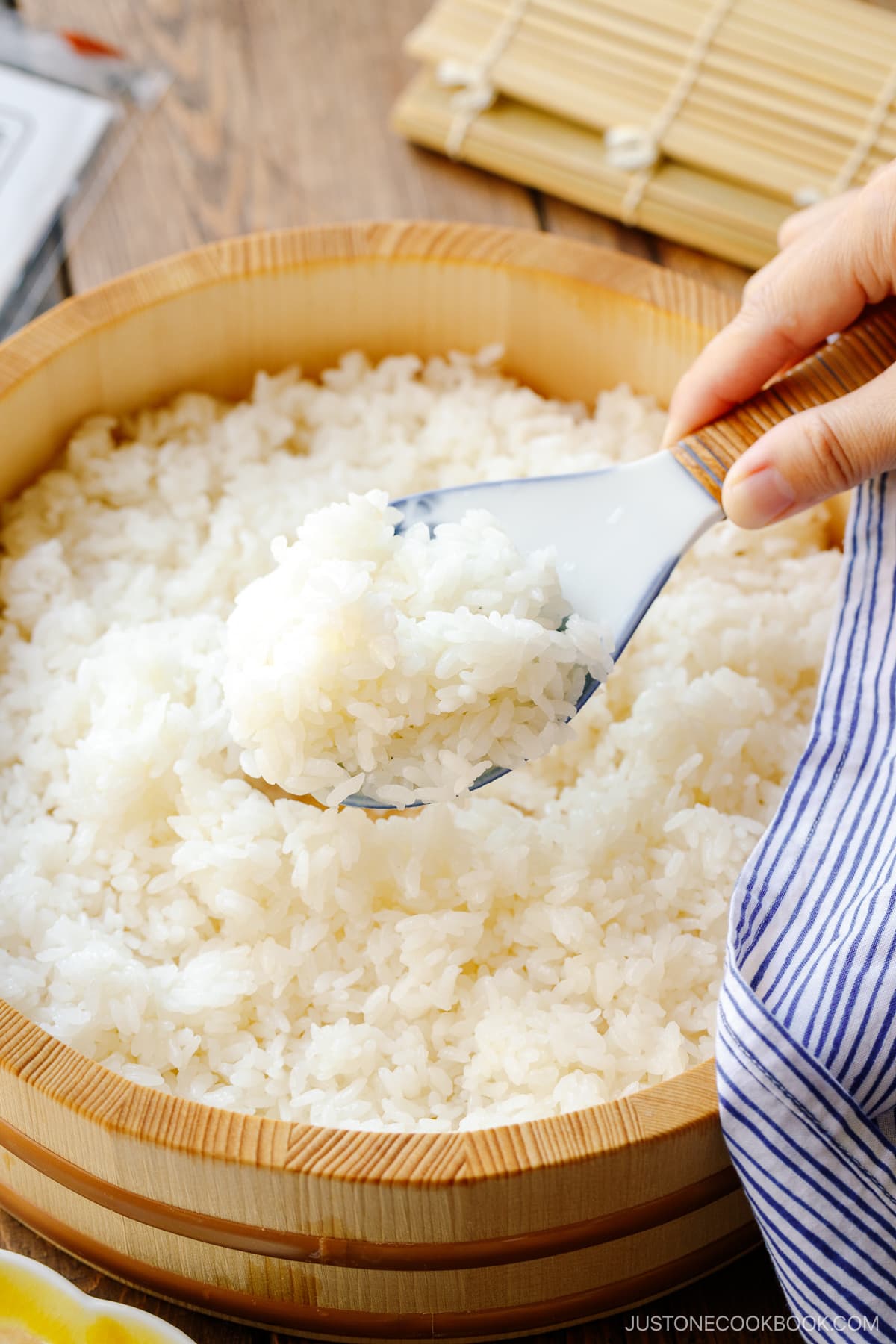 Sushi oke (Hangiri) containing sushi rice made with cooked Japanese short-grain rice, rice vinegar, sugar, and salt.