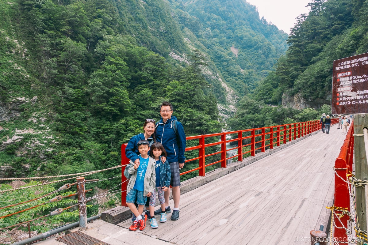 a family on Okukane Bridge at Keyakidaira Kurobe Gorge